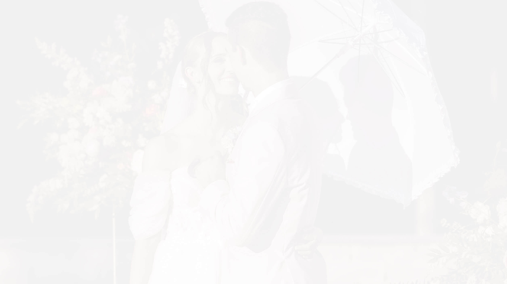 Сouple wearing a white gown and a white suit