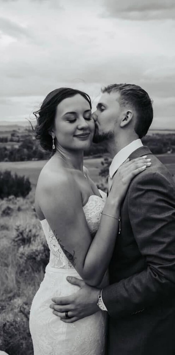 Сouple wearing a white gown and a black suit